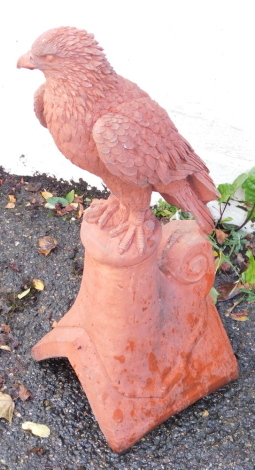 A terracotta ridge tile, surmounted with a bird of prey, 55cm high. (AF)