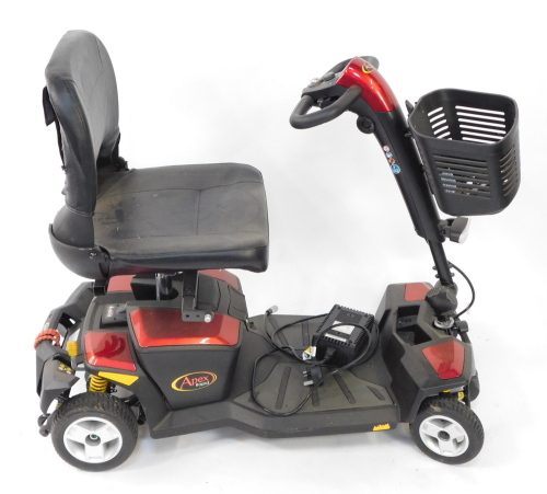 An Apex Rapid 4 wheel mobility scooter, with front basket and charger, in red and black trim.