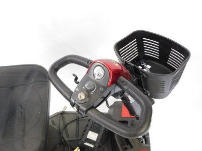 An Apex Rapid 4 wheel mobility scooter, with front basket and charger, in red and black trim. - 2