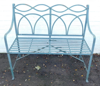 A green metal two seater garden bench, 102cm wide.