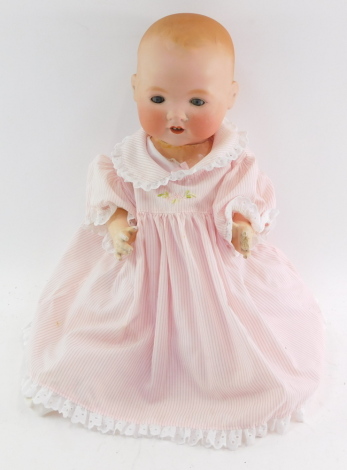 An Armand Marseille bisque head doll, 351/7K, modelled open mouthed, with blue eyes, jointed limbs, 52cm high.