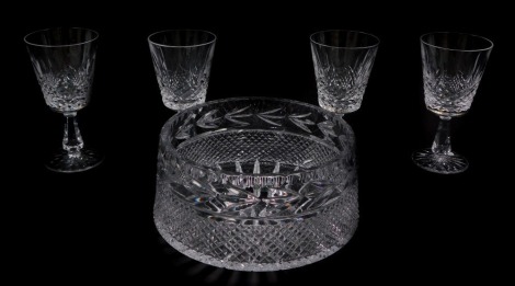 A set of four Waterford Crystal goblets decorated in the Lismore pattern, together with a Galway cut glass fruit bowl. (5)