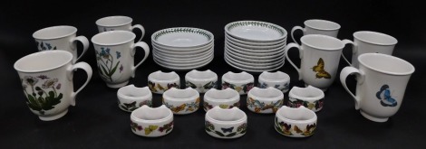 Eight Portmeirion pottery coffee mugs and saucers decorated in the Botanic Garden pattern, together with ten tea plates and twelve napkin rings.