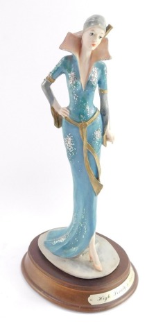 A Leonardo figure modelled as High Society, raised on an oval base, 29cm high.