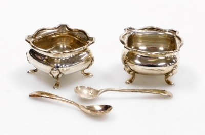 A pair of George V silver salts, each square with fluted body on tripod feet, Birmingham 1918, together with two later silver mustard spoons, London 2¼oz.