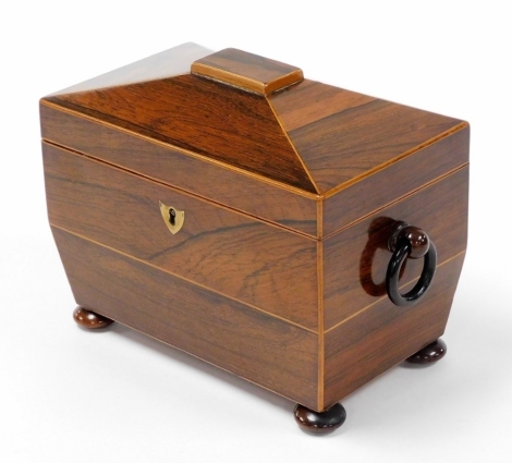 A 19thC rosewood tea caddy, with a domed top, opening to reveal two sections each with bone handle, and a brass shield escutcheon, and ring handles, on bun feet, 17cm high, 19cm wide, 12cm deep.