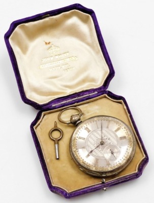 A pocket watch, with heavy elaborate silver coloured dial, and outer gilt scroll detailing, with Roman numerals and seconds dial, with blue hands, in a white metal case with vacant shield back, white metal, unmarked, numbered 75573 Argent, 3oz gross, key