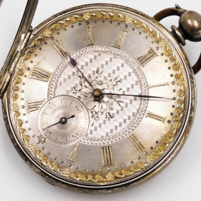 A pocket watch, with heavy elaborate silver coloured dial, and outer gilt scroll detailing, with Roman numerals and seconds dial, with blue hands, in a white metal case with vacant shield back, white metal, unmarked, numbered 75573 Argent, 3oz gross, key - 2