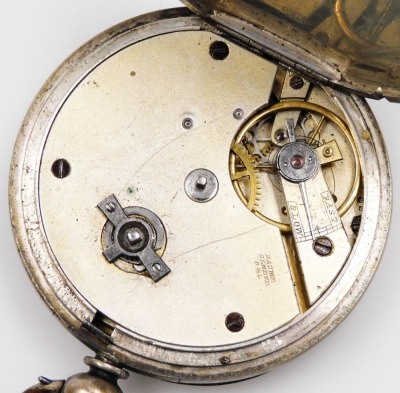 A pocket watch, with heavy elaborate silver coloured dial, and outer gilt scroll detailing, with Roman numerals and seconds dial, with blue hands, in a white metal case with vacant shield back, white metal, unmarked, numbered 75573 Argent, 3oz gross, key - 3