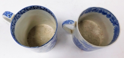 A large 19thC Pearlware mug, with blue and white transfer landscape and figure decoration, 9cm high, and another with transfer decoration of thorns and fruit, 11.5cm high. (AF, 2) - 3