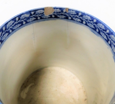 A large 19thC Pearlware mug, with blue and white transfer landscape and figure decoration, 9cm high, and another with transfer decoration of thorns and fruit, 11.5cm high. (AF, 2) - 4