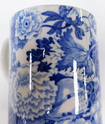 A large 19thC Pearlware mug, with blue and white transfer landscape and figure decoration, 9cm high, and another with transfer decoration of thorns and fruit, 11.5cm high. (AF, 2) - 5