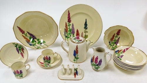 A Booths Hollyhock pattern part service, comprising dinner plate, serving bowl, leaf plate, seven bowls, teapot, toast rack, milk jug, two coffee cans and saucers.