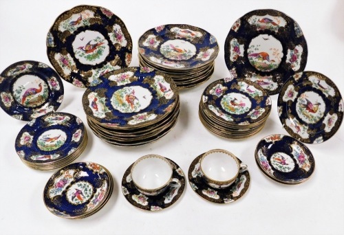 A group of Booths dinner wares, comprising dinner plates with a royal blue ground with gilt detailing with pheasants and posies groups numbered 1127, comprising twenty one dinner plates, eleven side plates, two teacups, nine small plates and five saucers.