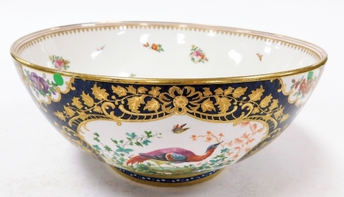 A Booths punch bowl, heavily decorated on a royal blue ground with gilt decoration and figures of pheasants and flowers, 28cm diameter, 13cm high. (AF)