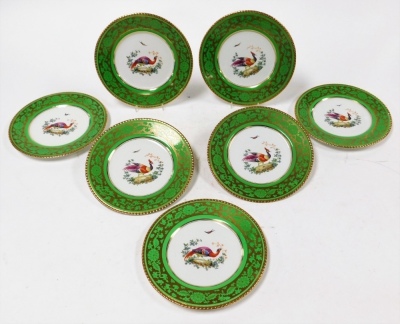 A set of seven Booths cabinet plates, with a lime green outer ground with gilt decoration with painted Asiatic pheasant and floral design numbered 1127, 23cm wide.