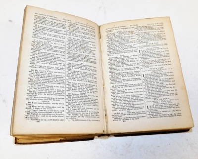 A 19thC leather bound Holy Bible, with inscription dated 1835, with a Christian motto crest to exterior. (AF) - 2