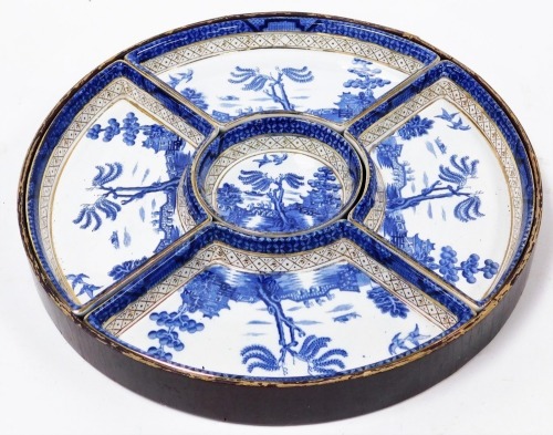 A Booths Real Old Willow pattern hors d'oeuvres dish, with circular central trinket and four outer dishes in a wooden circular tray case, 31cm diameter.