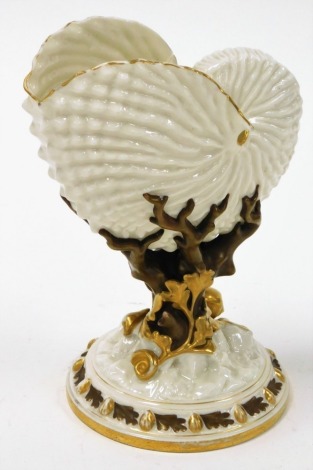 A Royal Worcester shell vase, the moulded cornucopia shell top on a flared tree type stem with gilt and brown mottled detailing, with purple stamp to underside, 21cm high.