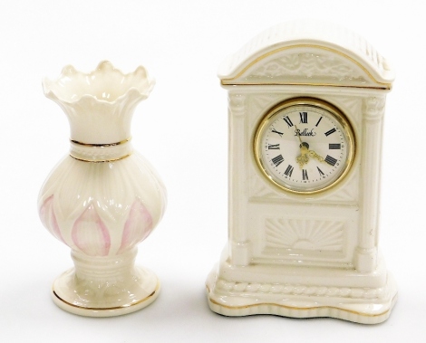 Two items of Belleek, to include a vine clock, 20cm high, and a pink floral flared vase, 16cm high. (2)