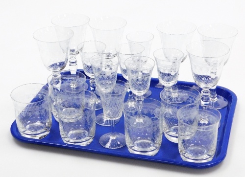 A set of drinking glasses, each with etched detailing with cross and circular border, comprising six tumblers, six sherry glasses and six wine glasses.