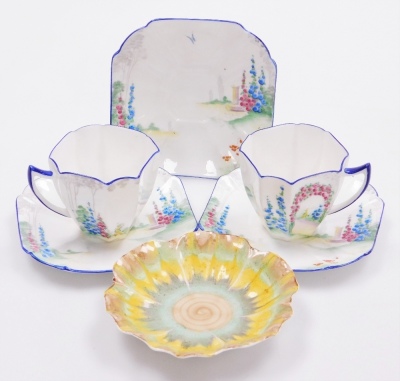 A group of Shelley porcelain, to include two Shelley teacups and three saucers, in bluebell pattern, together with a Shelley brown green and yellow sunflower dish. (6)