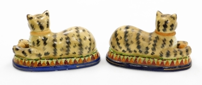 A pair of Staffordshire style seated cats, each cat with ball on a green stepped base on blue circular surround, unmarked, 15cm high, 23cm wide. - 2