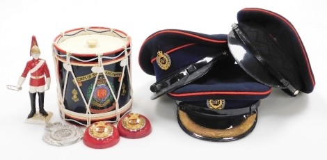 A group of Royal Engineers caps and memorabilia, to include a drum decanter, model of a Royal Engineer, two paperweights, crested badges and three caps.