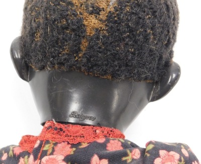 A Pedigree Afro Caribbean doll, in a floral dress, with cream shoes, 39cm high. - 2