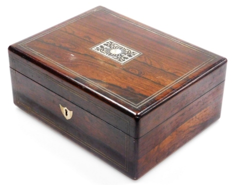 A late 19thC rosewood dressing case, with a brass banded and mother of pearl inlaid exterior opening to reveal a crushed velvet lid and boxed sectional interior with mother of pearl handles and silver plated topped glass bottles, with a mother of pearl es