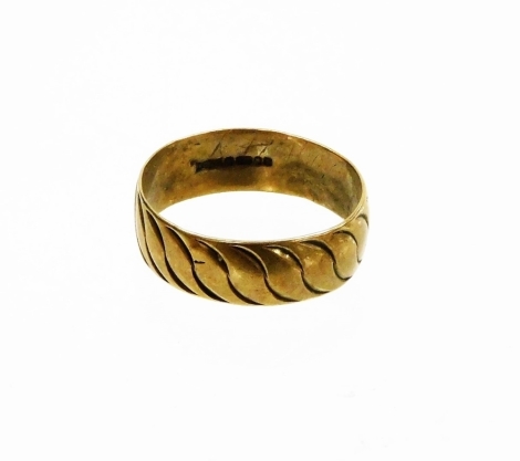 A 9ct gold thick wedding band, with hammered wave design, ring size T, 3.4g, misshapen.