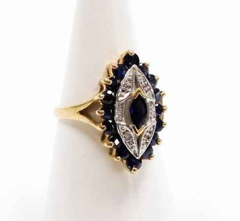 A 9ct gold dress ring, with shaped marquise ring head, with central sapphire surrounded by tiny cz stones, in a white and yellow gold setting, ring size O, 3.8g all in, boxed.