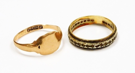 Two rings, to include a 9ct gold gents signet ring, worn, ring size P½, 1.8g, and a 9ct gold eternity ring set with cz stones, ring size P½, 2.7g all in. (2)