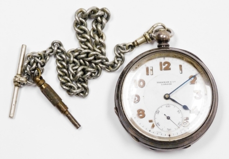 A silver Freeman and Co of London pocket watch, with white enamel dial and painted numbers and seconds dial, with blue hands on a silver plated watch chain, 110.5g all in.