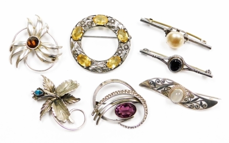 A group of silver and other brooches, to include a circular Celtic silver brooch with citrines, a STG silver sunflower brooch with central brown paste stone, a silver lily brooch stone set, three bar brooches, and a further twist design brooch, some plate