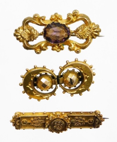 Three various brooches, to include a filigree detailed bar brooch in Victorian style, 4cm wide, yellow metal, unmarked, a gold plated and purple paste stone set bar brooch, 4cm wide, and a Victorian two crescent moon bar brooch, possibly silver gilt, 3.5c