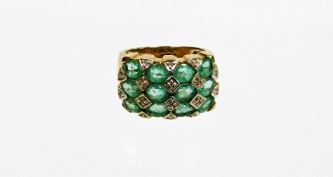 A 9ct gold emerald and diamond dress ring, with four rows of oval cut emeralds, with illusion set tiny diamonds, on a yellow metal band marked 375, 7.4g all in, boxed.