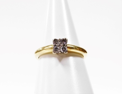 A diamond dress ring, with square panel set with four large outer diamonds and tiny diamond to centre, in a platinum setting on a yellow metal band, stamped 750, ring size P, 3.3g all in.