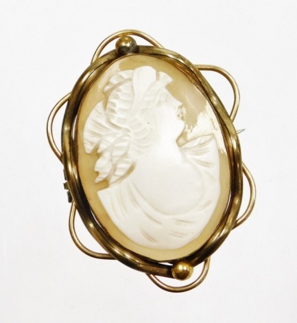 A late 19thC shell cameo brooch, with oval cameo depicting maiden, in a rolled gold scroll design case, on a single pin back, 5.5cm x 4cm.