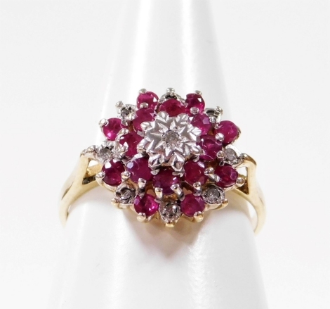 A 9ct gold dress ring, set with graduated rubies and diamonds, in a raised basket setting, ring size N, 2.3g all in.