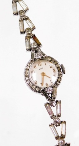 A Vidar ladies cocktail watch, with small circular watch head with gold hands, on a paste stone set bracelet in plated casing. (AF)