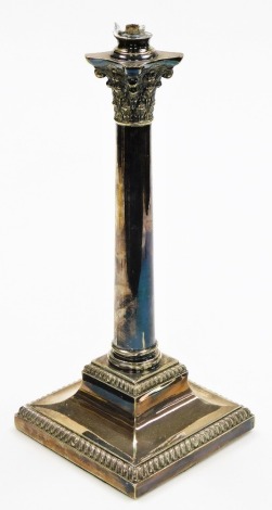 An early 20thC silver plated candlestick, converted to a table lamp, with Corinthian column support on a stepped base, 36cm high, 15cm wide.