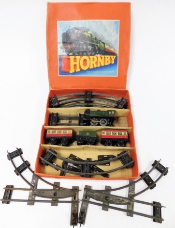 A Hornby cased train set, with track, green livery engine, and carriage, along with two Hornby 9798 red carriages, boxed.