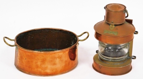 Two copper items, to include a copper ship's lantern bearing the badge for mast head, 26cm high, together with a copper two handled pan, 23cm wide.