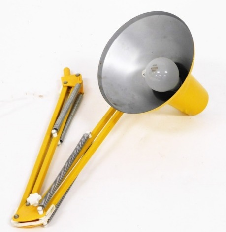 A yellow Anglepoise desk mounted lamp, 80cm high when fully extended.