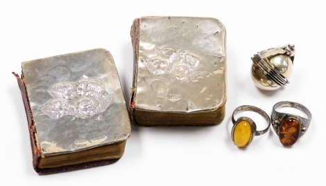 A small group of silver wares, to include two silver fronted miniature bibles, each with cherub detailed panel, a silver part bracelet and two stone set dress rings, 1oz gross.