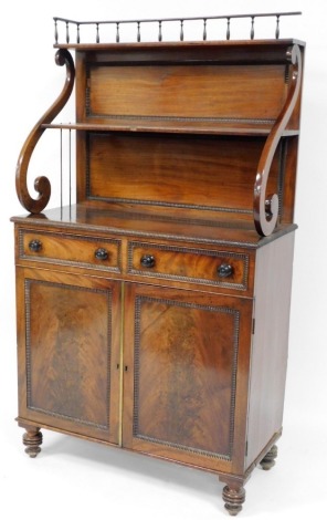 A George IV mahogany chiffonier, with gadrooned borders, the raised back with spindle framed gallery and two shelves, on 'S' shaped supports, the base with two drawers above two panelled doors on bun feet, 162cm high, 91cm wide, 44cm deep.