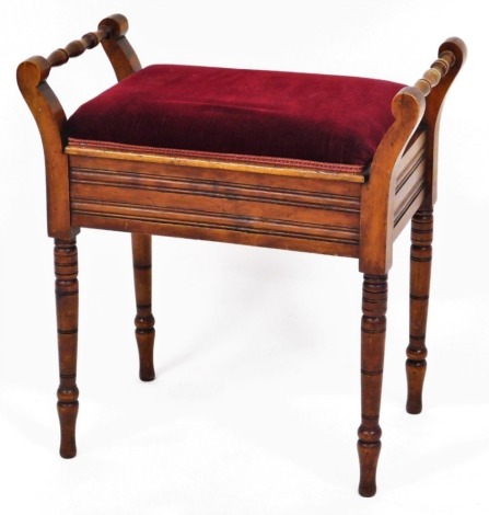 An Edwardian walnut piano stool, with red velvet cushion top and ribboned detailed on lift up hinged lid, with tapered legs, 61cm high, 57cm wide, 34cm deep.