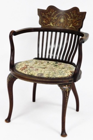 An Edwardian inlaid elbow chair, with slated back and carved shield crest with parquetry detailing of Medusa's head and leaves and vines, on a floral upholstered seat with buttoned detailing, 90cm high, 55cm wide, 43cm deep.