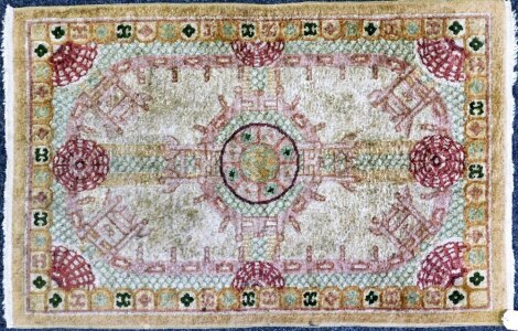 A Chinese wool cut rug, 61cm x 95cm.